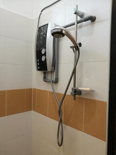 a shower in a bathroom with a shower head at Barakah Homestay in Alor Setar