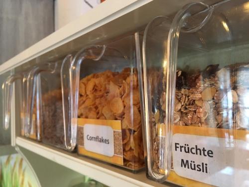 a display of different types of food in glass jars at "0" Sterne Hotel Weisses Rössl in Leutasch/Tirol in Leutasch