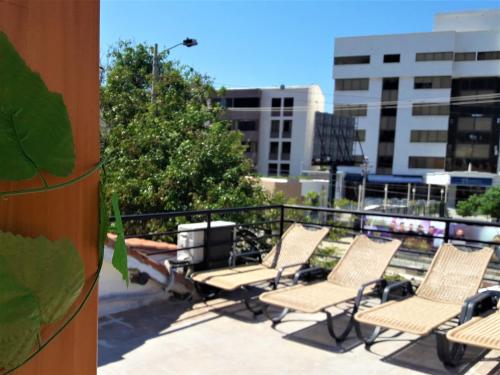 a group of chairs sitting on top of a balcony at Hotel Rodadero Dorado in Santa Marta
