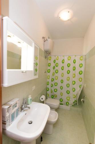 a bathroom with a sink and a toilet and a mirror at Il Mandorlo in Ficulle