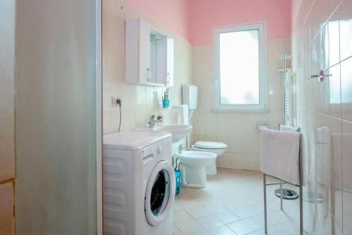 a bathroom with a washing machine and a washer at Residence Kimba in Rimini