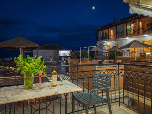 a table and chairs on a balcony at night at Panorama Apartments in Chrani