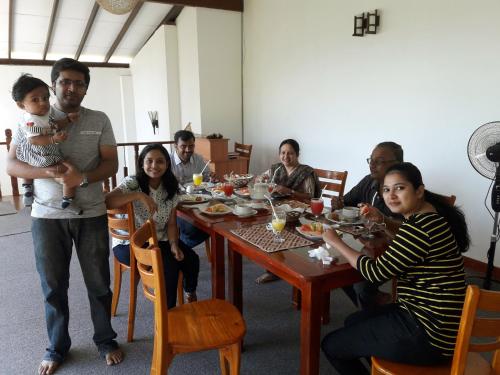 a group of people sitting around a table at Nico Lagoon Hotel in Negombo