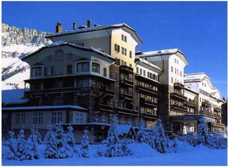 a large building on top of a snow covered mountain at Residence Grand Hotel Carezza in Nova Levante