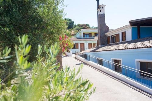 a view of a walkway between two buildings at La Corte Degli Ulivi in Cardedu
