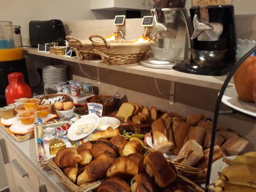 a bunch of bread and pastries on a counter in a kitchen at La Caravelle in Riom
