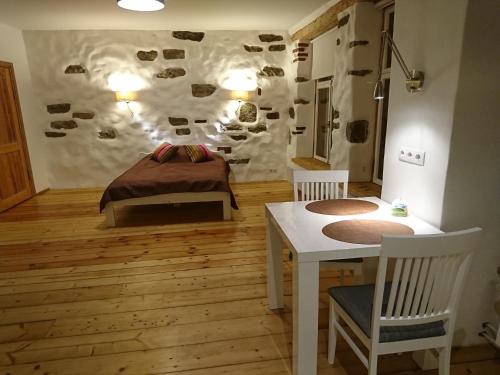 a bedroom with a bed and a table and chairs at Old Town Niguliste Residence in Tallinn