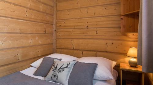 a bedroom with a bed in a wooden room at Pokoje Gościnne Chochołów in Chochołów
