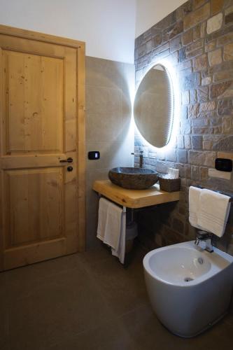 a bathroom with a sink and a mirror at Hotel Sogni D'Oro in Camporosso in Valcanale