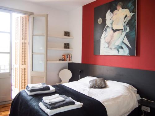 a bedroom with a bed with towels on it at Torres Rojo in Barcelona