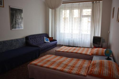 a living room with two beds and a couch at Apartment Aida in Prague