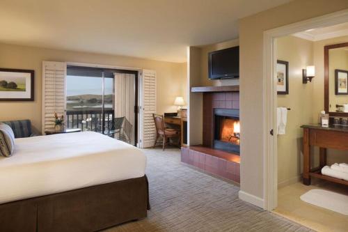 a hotel room with a bed and a fireplace at The Lodge at Bodega Bay in Bodega Bay