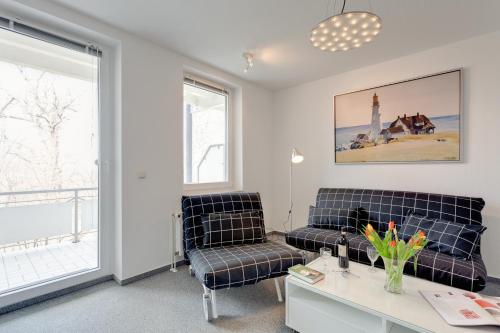 a living room with two chairs and a table at Möwe in Göhren