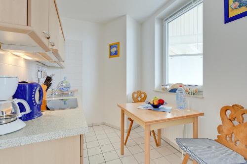 a kitchen with a table and a counter top at Möwe in Göhren