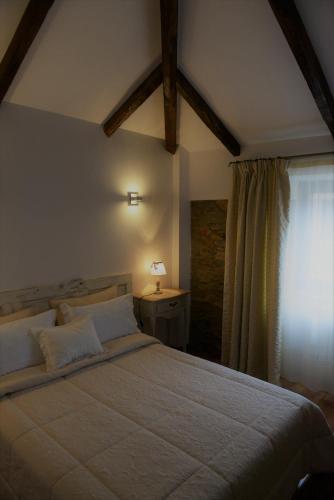 a bedroom with a large bed and a window at Casa da Fraga in Ferreira