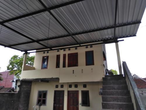 a building with awning over the front of it at Kona backpaker syariah in Yogyakarta
