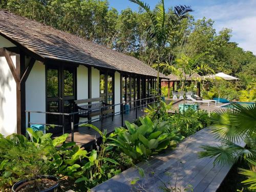 a resort with a garden and a patio at Koyao Bay Pavilions - SHA Extra Plus in Ko Yao Noi