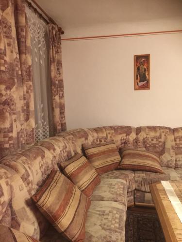 a large couch sitting in a living room at Apartmán Verona in Český Krumlov