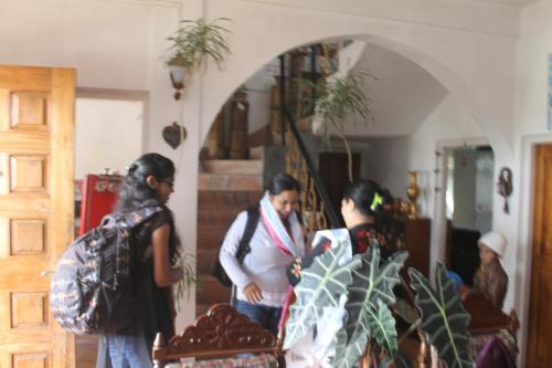 a group of people standing in a room at Mansarover Home Stay in Kalimpong