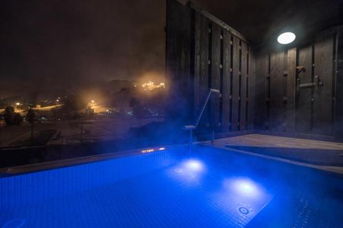 a swimming pool in a building at night at Maruyama Onsen Kojyokan in Minami Uonuma