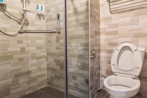 a bathroom with a toilet and a shower at Grand Inter Hotel in Samut Sakhon