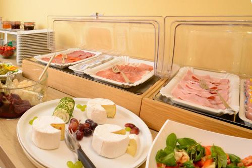 a table with two plates of food in a refrigerator at Barcelona Bed & Breakfast in Düsseldorf