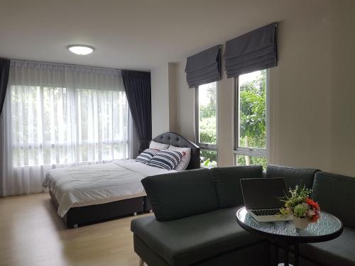 a living room with a couch and a bed at Dcondo Kathu Patong Phuket by Jack in Kathu