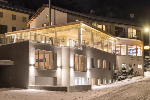 a large white building with a lot of windows at Laagers Hotel Garni in Samedan