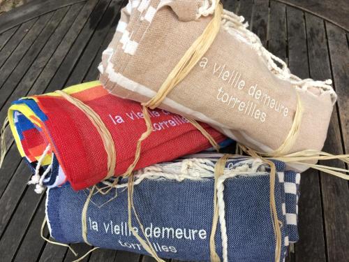 a pile of rolled up towels sitting on a table at La Vieille Demeure in Torreilles