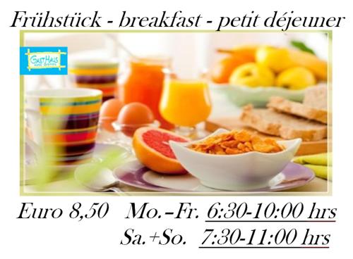 a breakfast table with a plate of food and drinks at GastHaus Hotel Bremen in Bremen