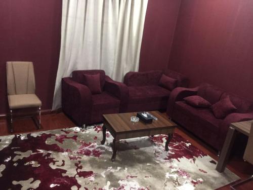 a living room with two couches and a coffee table at شقق الماسة التاج للوحدات السكنية in Hail