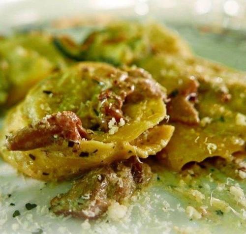 a plate of food with pasta with sauce and cheese at Locanda-Trattoria Al Rio in Cinto Euganeo