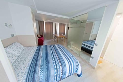 a bedroom with a blue and white bed and a mirror at Luxury and cozy apartment MALAGA in Málaga
