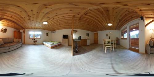 a large living room with a large wooden ceiling at Apartma & savna Slapnik in Luče