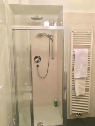 a shower with a glass door in a bathroom at Appartamento Nadia in Merano