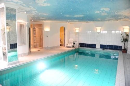a large swimming pool with a ceiling covered inpired at Hotel Kienberger Hof in Pfronten