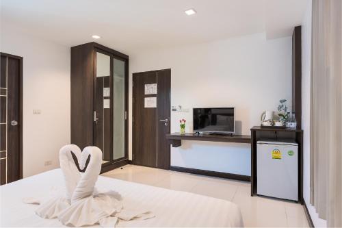 a room with a bed with a heart sculpture on it at U Hatyai Hotel in Hat Yai