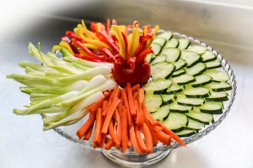 a glass bowl filled with carrots and cucumbers at Hotel Riziana in Cervia