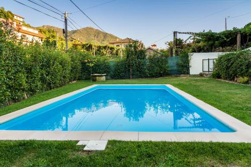 a swimming pool in the yard of a house at Casa da Oliveira in Mondim de Basto