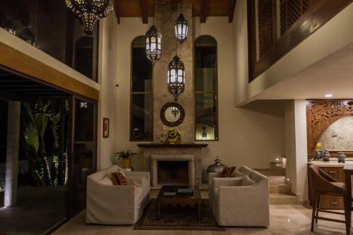 a living room with chairs and a fireplace at Hotel Lindo Ajijic Bed & Breakfast in Ajijic