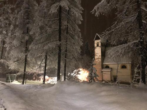 a small building in the snow at night at TH Borca di Cadore - Park Hotel Des Dolomites in Borca di Cadore