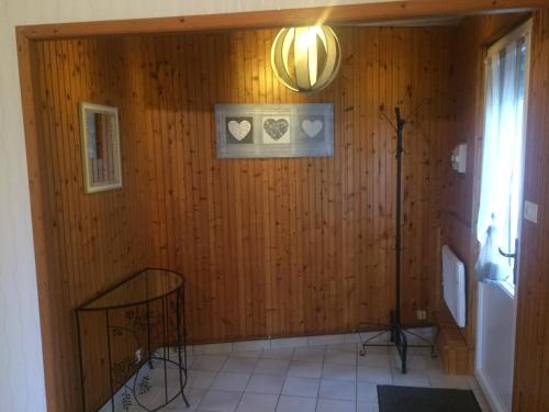 a hallway with a wooden wall with hearts on it at gite victoria in La Pommeraie-sur-Sèvre