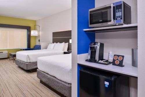 a hotel room with two beds and a tv at Holiday Inn Express - Bethlehem, an IHG Hotel in Winder