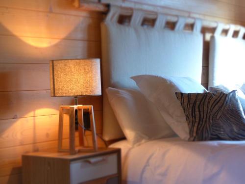 a bedroom with a bed with a lamp on a night stand at Piedrafita Mountain in Piedrafita de Jaca