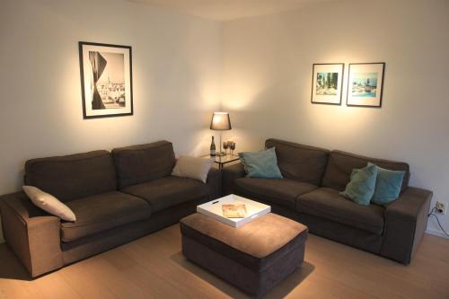 a living room with a couch and a coffee table at NEW Design apartment in Brussels in Brussels