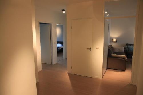 a hallway with a living room and a couch at NEW Design apartment in Brussels in Brussels