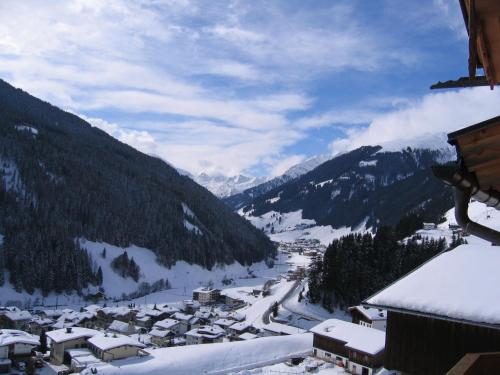 a view of a village in the mountains with snow at Honsnhof in Tux