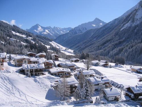 a village covered in snow with mountains in the background at Honsnhof in Tux