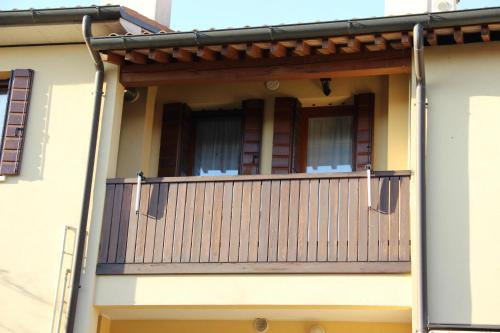 a balcony of a house with a wooden railing at Boccaor in Paderno del Grappa