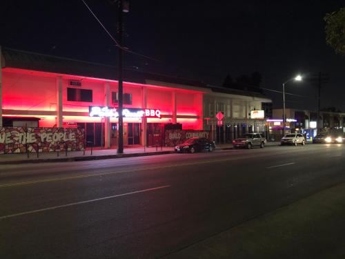 a building with red lights on a street at night at Knights Inn Los Angeles Central / Convention Center Area in Los Angeles